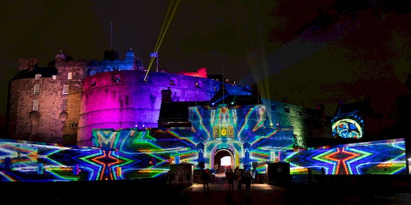 Exterior of Edinburgh Castle with lots of colour and pattern being projected onto it