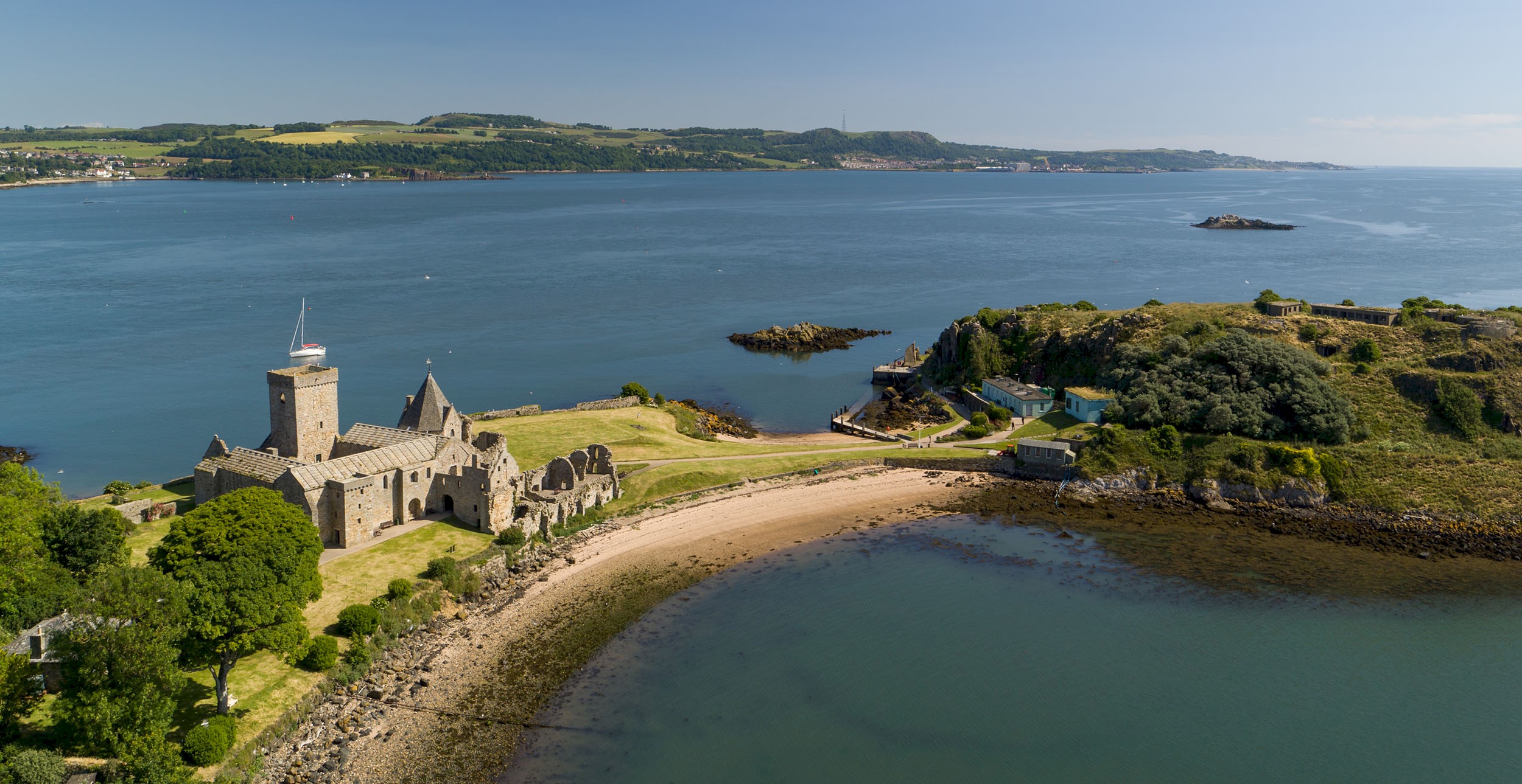 Aerial view of a beautiful abbey and island dominating the Firth of Forth