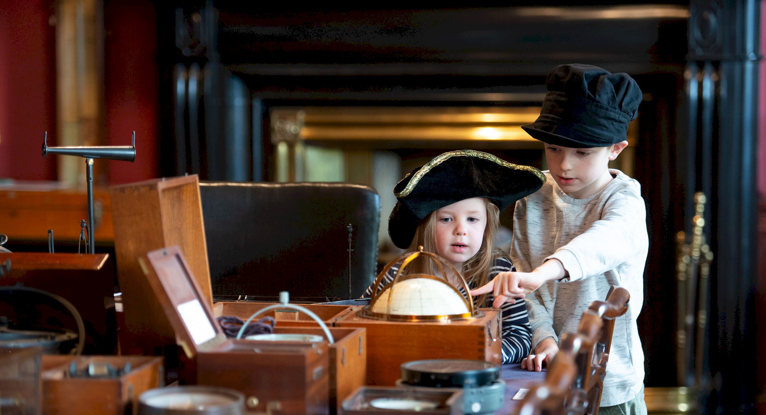 two children looking at objects in Trinity House