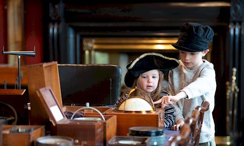 two children looking at objects in Trinity House