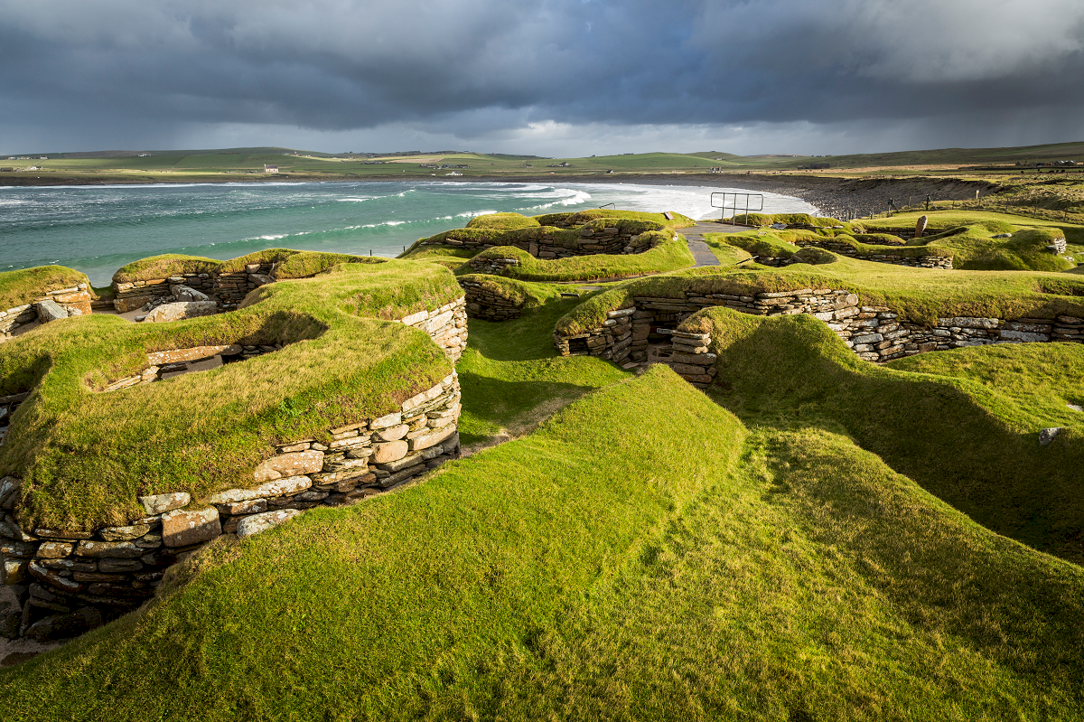 view out over the prehistoric village of Skara Brae with the sea in the background