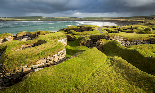 view out over the prehistoric village of Skara Brae with the sea in the background