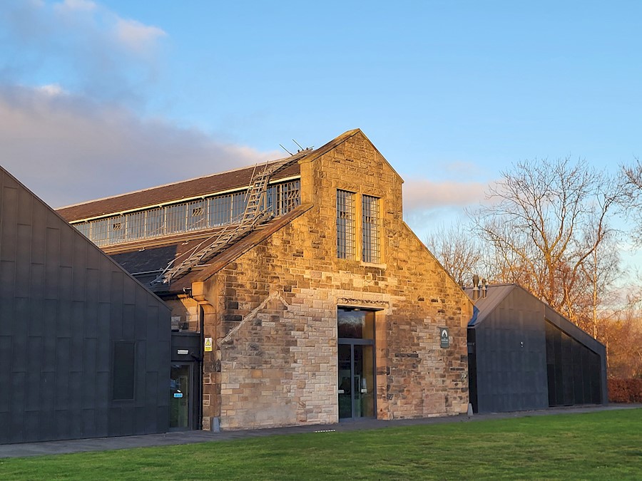 The Engine Shed building - a traditional blonde sandstone building with two modern black wings flanking the original building