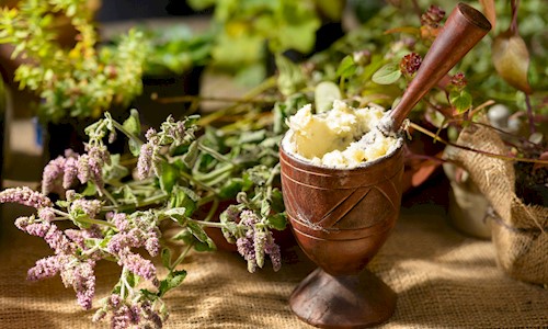 Some flowers and herbs in a mortal and pestle