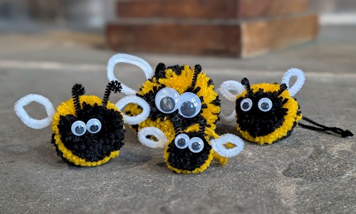 handcrafted bees made out of wool with googly eyes