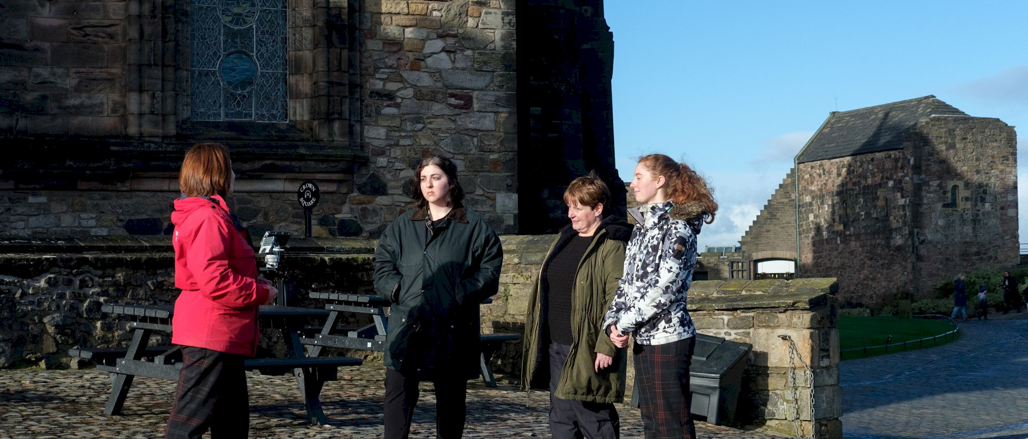 An Edinburgh Castle guide talking to women on a tour